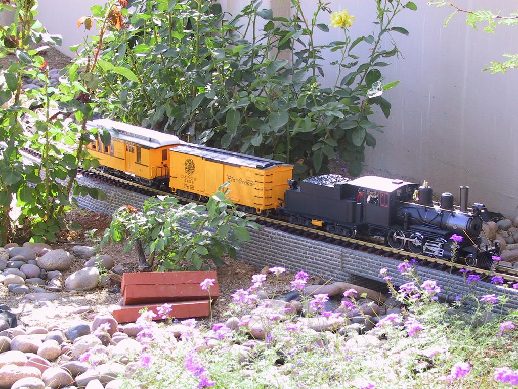 battery powered using trailing boxcars, and a mix of freight and passenger cars.