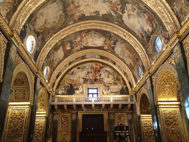 Preti designed the intricate carved stone walls and painted the vaulted ceiling and side altars with scenes from the life of St John.
