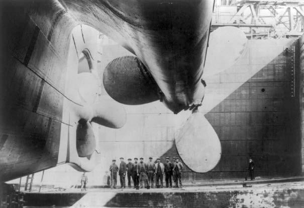 The size of the Titanic is clear in the comparison of the ship s propellers with the men in the background. The Unsinkable Ship The Titanic was built in 1911 to travel across the Atlantic Ocean.