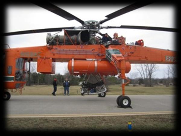 The helicopter is unique in that it has 3 pilot stations, one which faces aft at the load.