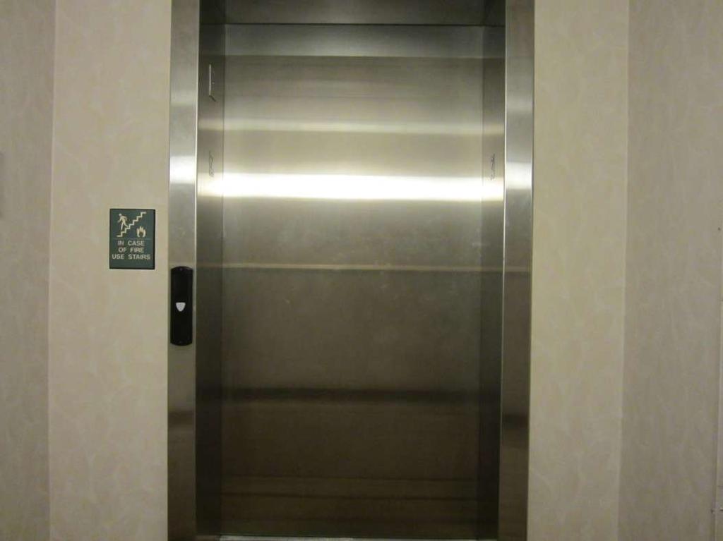 Door does not always open away from threshold mounted floor number sign.