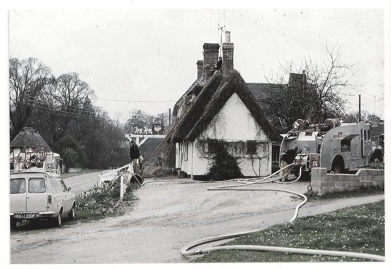 Newport Fire Brigade removing burning thatch from the roof in the 1960s.