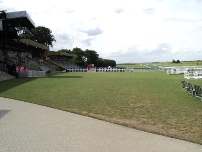 There is a hard standing paved pathway located in front of the Grandstands in the Premier Enclosure. Please note that the rest of the arearacecourse side of the grandstand is grassed.