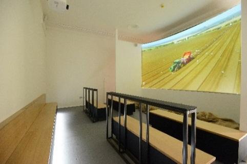 There is farming equipment suspended from the ceiling towards the beginning of the