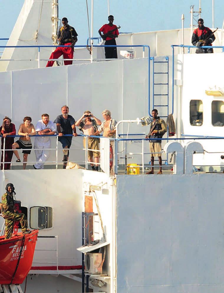 Armed Somali pirates watch over the MV Faina crew following a request by the US Navy to monitor the crew s health 8