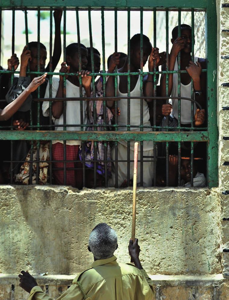A prison warden tries to control inmates at 18 Berbera prison, Somaliland.