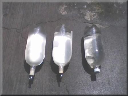 Figure 6. Comparison of jacketed aluminum and white plastic SODIS bottles (left) with a basic SODIS bottle (right).