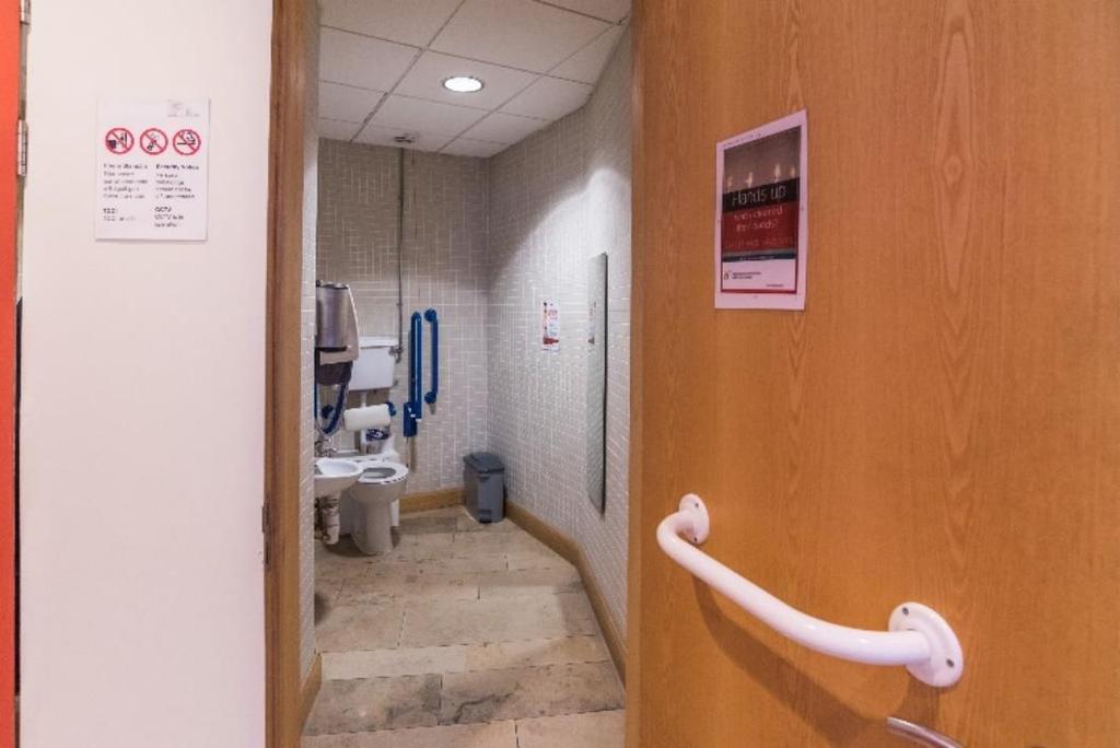 The door to each toilet opens outwards towards the reception area.