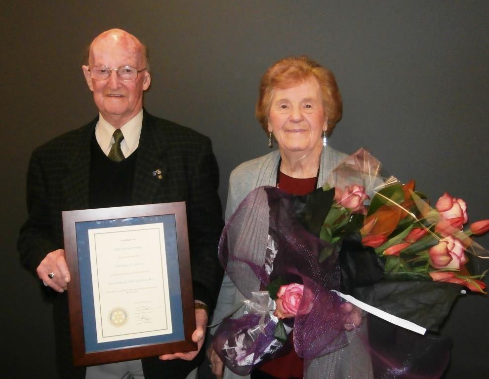 certificate by President Trevor Donegan, and his wife Janet with