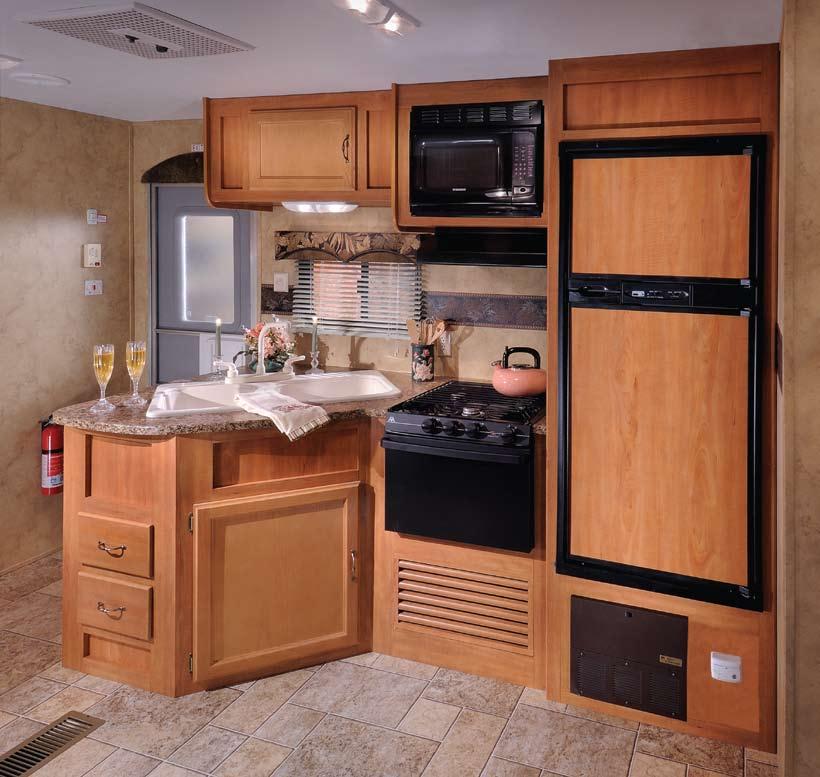 - Largest kitchen sink in the industry - All wood drawers - Large double Door Refrigerator - Silverware Tray -