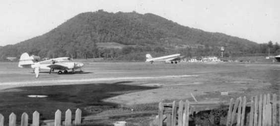 A 1954 photo by James Brown of Asheville-Henderson, showing a Piper Apache & a Delta DC-3. The DC-3 airliners that served the airport were Capitol, Delta, and Piedmont Airlines.