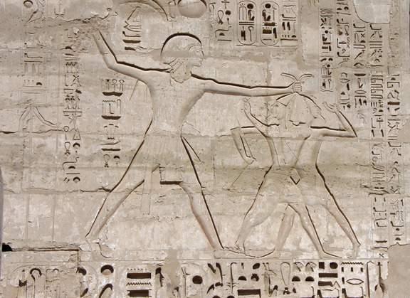 The larger temple, dedicated to three major Egyptian deities, features four large statues of Ramses II on its facade, while the smaller temple is dedicated to the love goddess Hathor, with statues