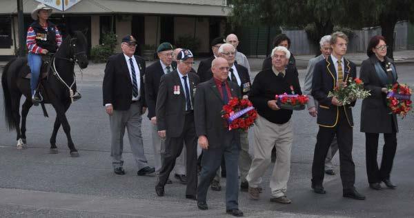 The marchers, some holding wreaths, halted on the footpath opposite the war memorial as the service began at 7am.