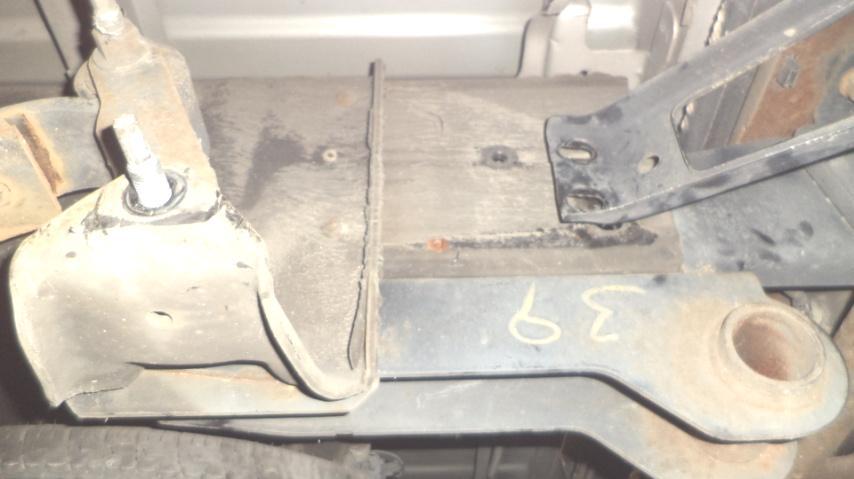 Step 1: Beginning on the driver side of the vehicle, remove the nuts and bolt plate (see photo 1.1) attaching the bumper bracket (if installed) to the side of the frame (18mm).