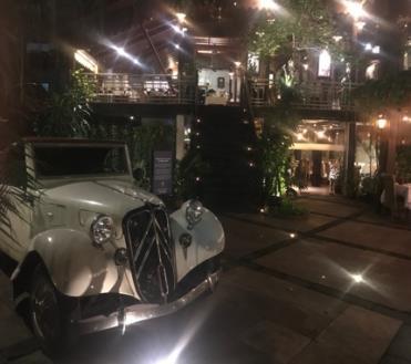 of delicacies in candle light perched above the vintage car at the main entrance.
