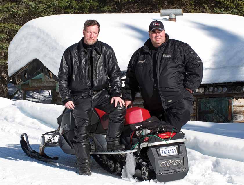 Dan Gould and Steve Gaudreau, of Panda Aventures, pose in front of an authentic log cabin, which was just about buried in snow. Steve noted that it wasn t the best year for snowfall in the region.