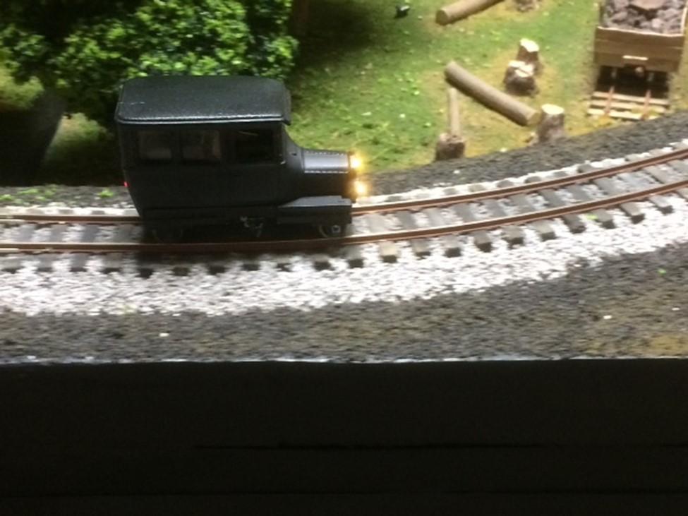 Below is a photo of the layout and a closeup photo of his dead-rail (hand held controller signal direct to an onboard battery with no rail power)