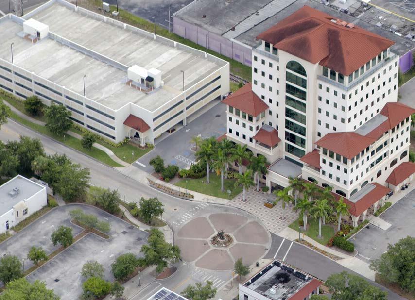 AREA INFORMATION LOCATION KANE PLAZA is a 10 story stucco and glass office tower in the South Florida style with a 4 story parking garage and 3 surface lots, located at the paved roundabout on the
