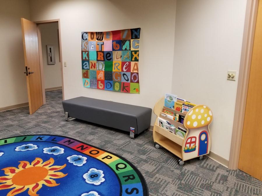 We have created a cozy area for parents and caregivers to sit down and read with their children!