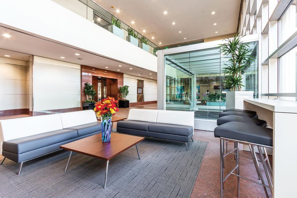 Two-story atrium w/balcony overlooking beautiful building lobby featuring