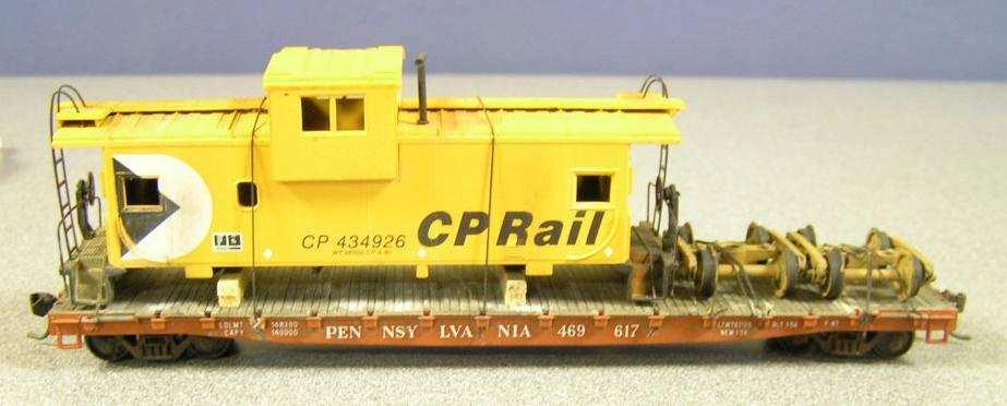 Contest Winners: First Place: CP Rail caboose on Pennsylvania RR flat care by Alan Hutchins Third Place: Vehicle frame load on Santa Fe flatcar by John Emmot Second Place: Earthmover on Santa Fe