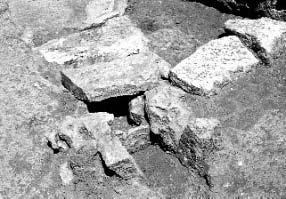 Fig. 22 - Flat stones blocking the channel. Fig. 23 - Well in A14. The wells discovered under the floors of the rooms A14 against wall M15 (Fig. 23) and A19 were 0.55x0.6 m and 0.45x0.