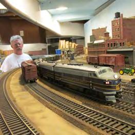 sceniced model railroad. WH Passengers on the Union depot platform seem oblivious to the massive B&O EM-1 slowly chuffing by them.