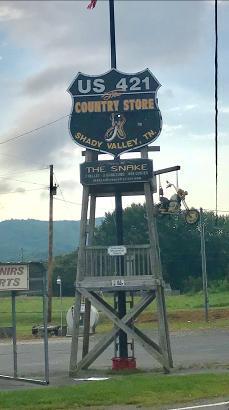 This picture shows a sign for a ride called The Snake. It goes over 3 mountains and has 489 curves. Butch and I rode this the other day. It s an excellent ride.