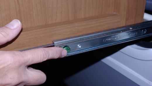 Appliances Slowly push the kitchen unit back to the retracted position. Insert the front latch bolt into the locking sleeve. Push the latch bolt to the lock position (lying flat against the cabinet).
