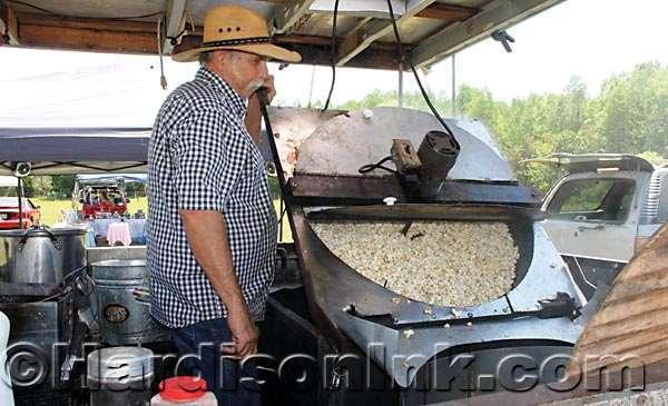 Mike Poindexter of Suwannee County pours kettle corn into a large holding