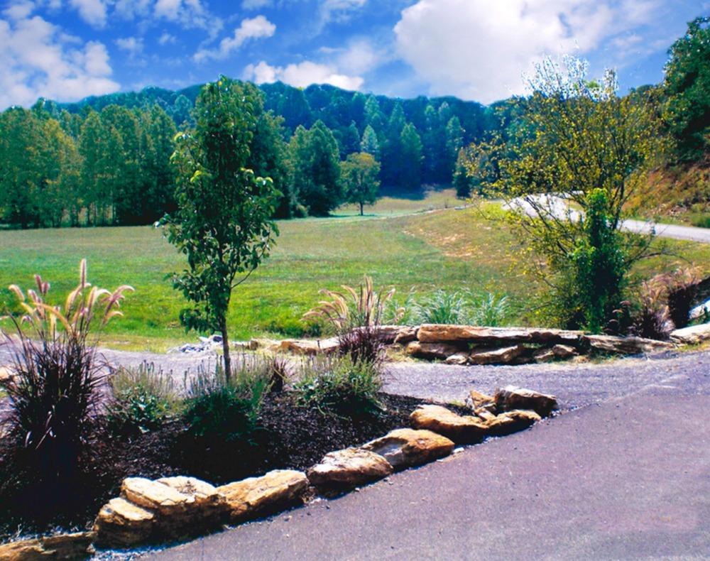 A beautiful stone bridge was completed to cross Happy Creek, which flows through the property. In addition, the property features an old barn, three ponds and several acres of scenic open pastures.