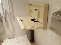 The wash basin can be reached from seated on the toilet. The wash basin is not placed higher than 74cm (2ft 5in). There is a vertical wall-mounted grab rail on the right hand side of the wash basin.