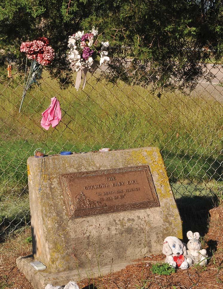 Her gravesite lies on AHTD right of way. It is surrounded by a chain link fence erected by the Department and AHTD crews maintain the grass around the site.