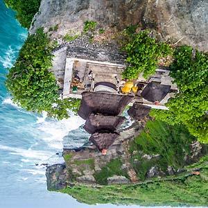 famous cliff-hanging temple at Uluwatu. Perched on the edge of a steep cliff, the temple sits 230 feet above the crashing waves of the Indonesian Ocean.