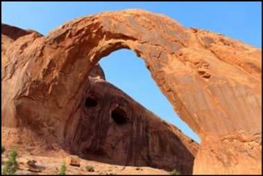 The arch spans 140 feet with a height of 105 feet. The trail is approximately 2.5 miles round trip from the parking lot to Corona Arch.