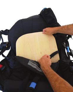 Lift up the seat cushioning and push the leg straps apart to create enough space to slide the seat plate into the