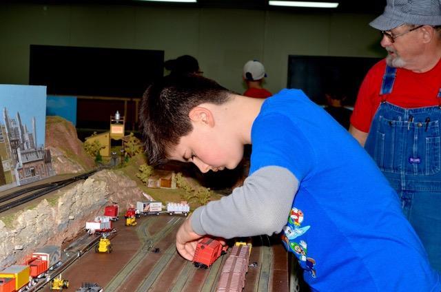 Lawrence Model Railroad Club A young model railroader assisting the Topeka Model Railroad Club with a boxcar at the 2016 Lawrence Model Railroad Club and Swap Meet.