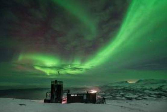 it is possible to see the Northern Lights dancing in the sky around you from this