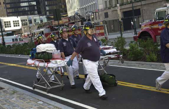 Many responders lost close friends and colleagues on 9/11. A New York Presbyterian Hospital EMS crew advances on the scene with their equipment.