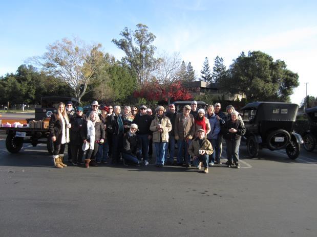 December 2017 Flash Tour The twenty-four occupants of the nine Model T's and one modern car parked in the shopping center lot in Sebastopol, gathered around the back of Chris Rich's '24 TT C-Cab