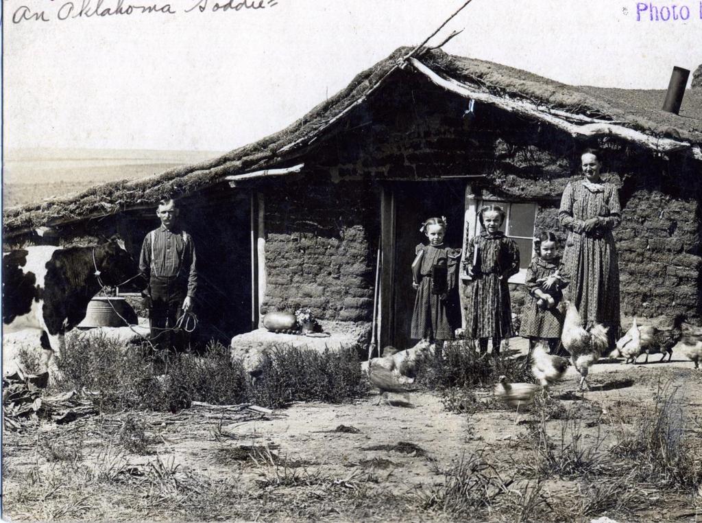 Primary Source: Living in a Sod House (Photograph) A family poses outside their sod house