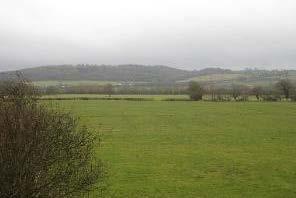 fields to the south, with distant views of the M5 motorway and Portbury