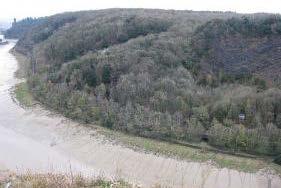 The railway line snakes through the landscape at the bottom of the gorge visible as a linear gap in the trees and makes up a small proportion of the overall view.