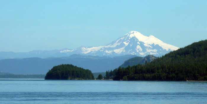 Traveling to Friday Harbor, San Juan Island Mount Baker looms into view as the ferry passes Lopez Island.