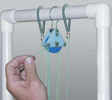 Pull the line up to the top pulley and thread it through the tube in the tie-off lug (Figure