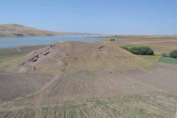 Çadır Höyük mound showing east slope Step Trench excavations (left side of mound) with Gellingüllü Lake behind the mound.