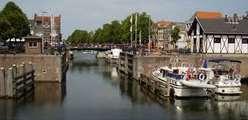 Biking further along the river Afgedamde Maas an old arm of the Maas river you will reach the medieval city of