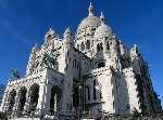 Visit Sacré-Coeur Basilica, a huge white church that dominates the Parisian skyline.