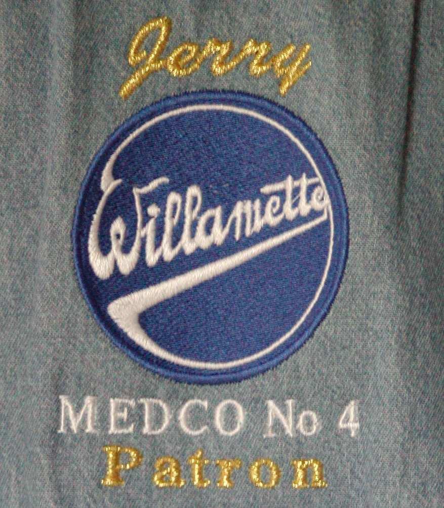 The gifts are blue denim shirts embroidered with the Willamette logo and Medco No. 4.