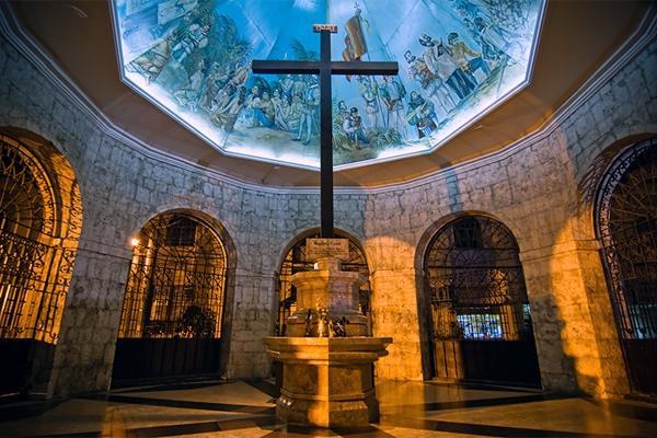 MAGELLAN S CROSS : a Christian cross planted by Portuguese and Spanish explorers as ordered by Ferdinand Magellan upon arriving in Cebu, Philippines implanted conquerors encased miraculous chip away